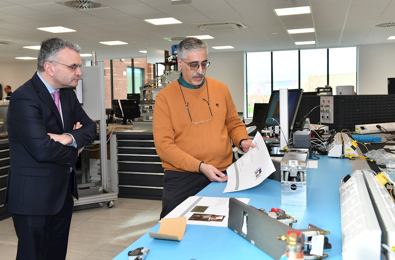 Minister of State at the Department of Enterprise Trade & Employment, Dara Calleary T.D., speaks with the Principle Physicist at ABB Ireland Ltd., Rambod Naimi, during a tour of the new Dundalk R&D Centre