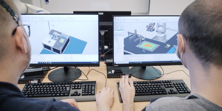 Students using robot programming software