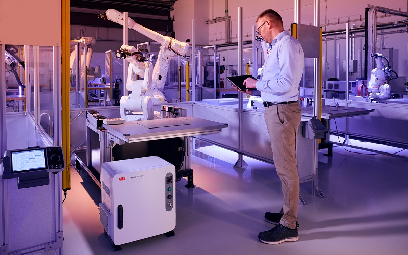 Technician working with an ABB robot and OmniCore