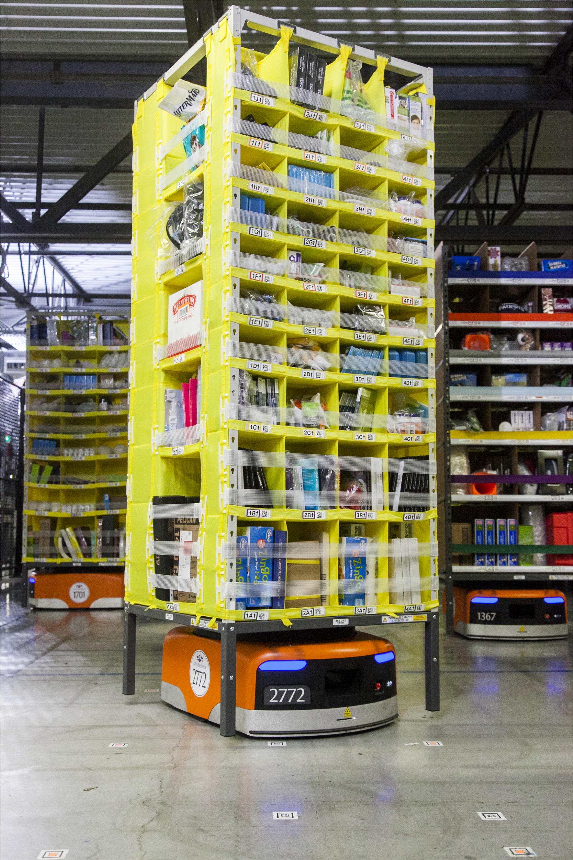 mobile robot in amazon robotics fulfillment center transporting goods to workers