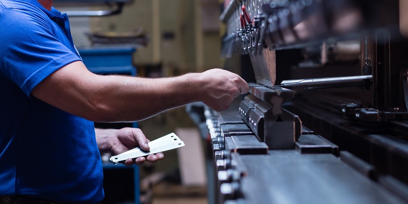 Worker near hydraulic press equipment