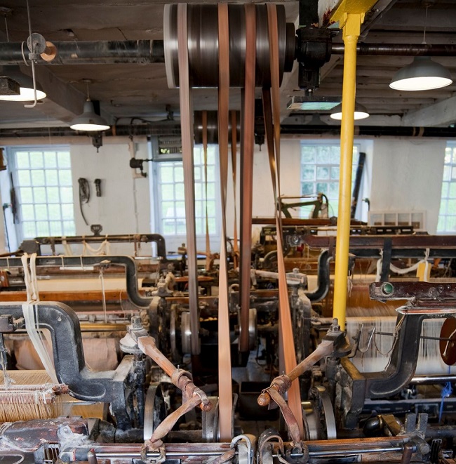 complex assembly line of machines, such as in textile factory, driven by central drive belt system