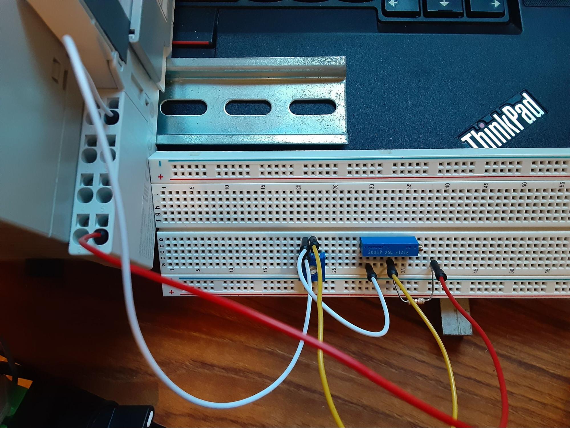 physical wiring and the schematic representation with connections to the 1734-IE2C module