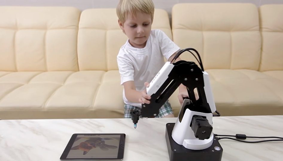 young child teaching Magician to swipe on his tablet
