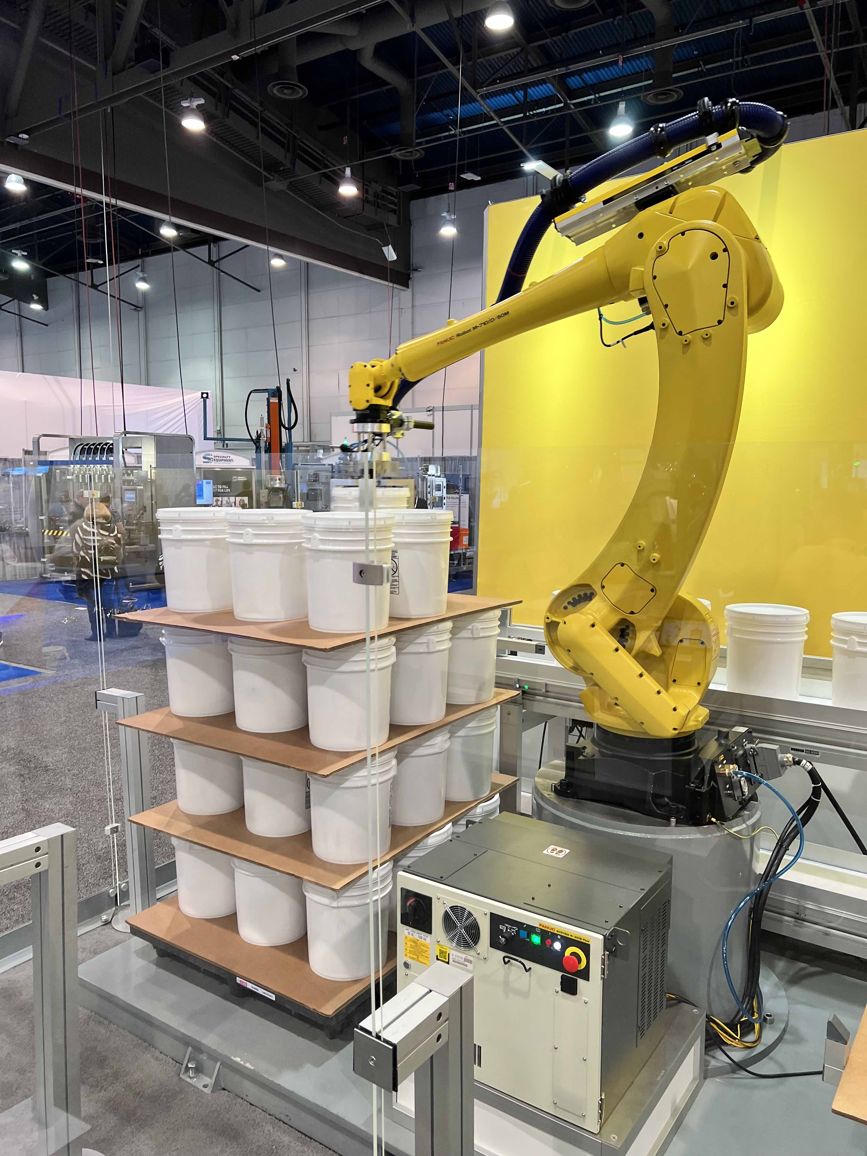 FANUC's yellow robots are a familiar site in increasingly smart warehousing environments. One of their more current offerings seen here at Pack Expo doing pick and place bucket palletizing.