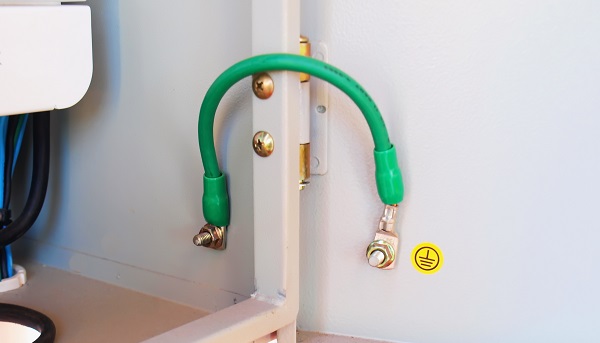 Panel door grounding strap