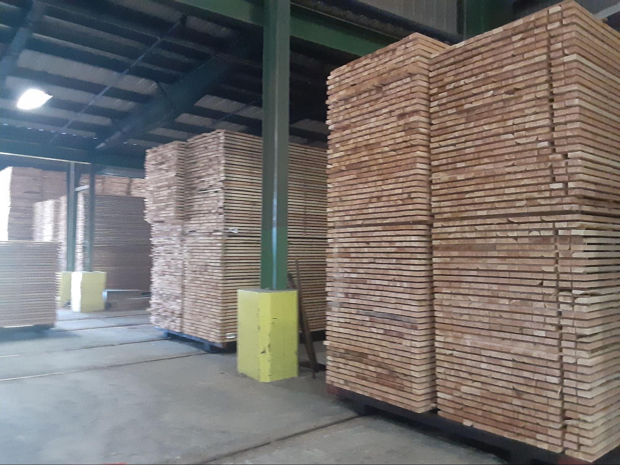 Dimensional lumber stacked outside the drying kiln
