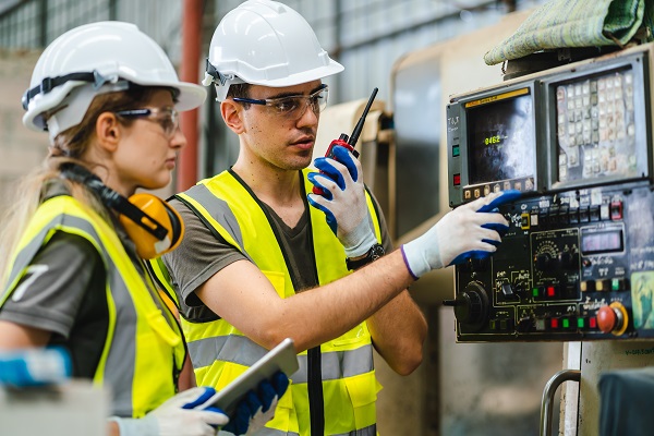 Technicians working on automated equipment