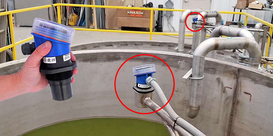 Ultrasonic level sensors mounted atop a water tank.