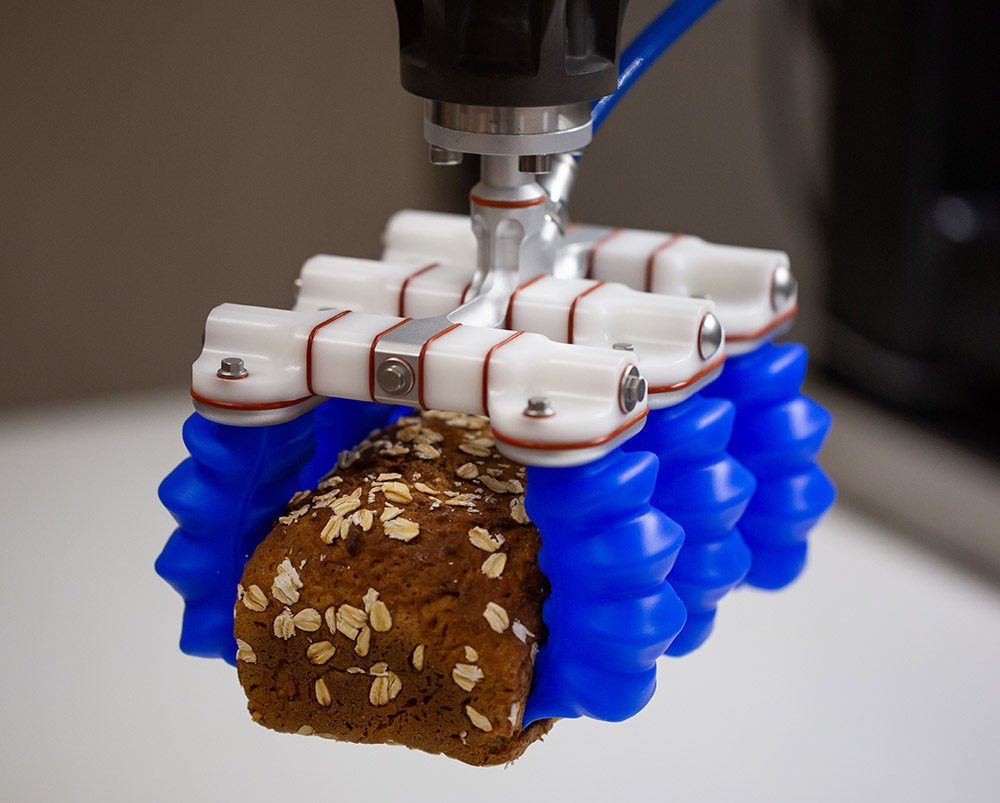 Soft Robotics' soft gripper being used to gently grab bread