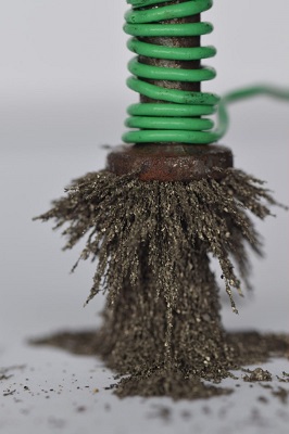 nail wrapped with a wire attracting iron fillings with DC voltage
