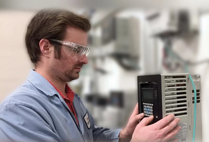 Tech adjusting parameters on a VFD