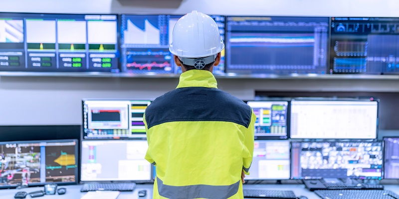 Operator looking at a computer in a powerplant
