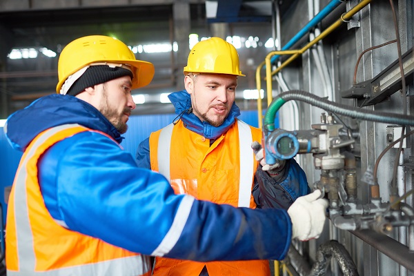 Powerplant operators adjusting a control valve