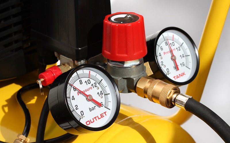Pressure gauges on an air compressor tank