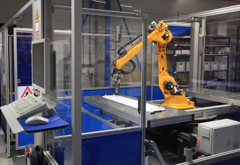 Designing robot cells to avoid operating near singularities