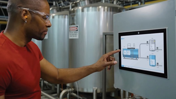 Technician using FactoryTalk Optix HMI device