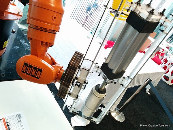 Robot with a coupling and a gripper attached