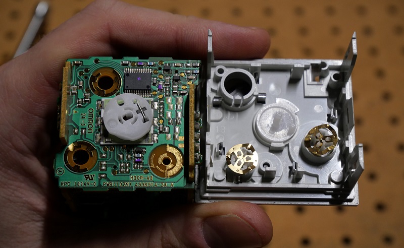 bottom side of adjustment dials with top side of main relay base