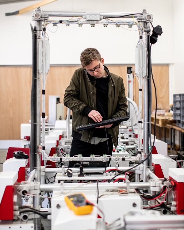 Technician entering data into a process machine