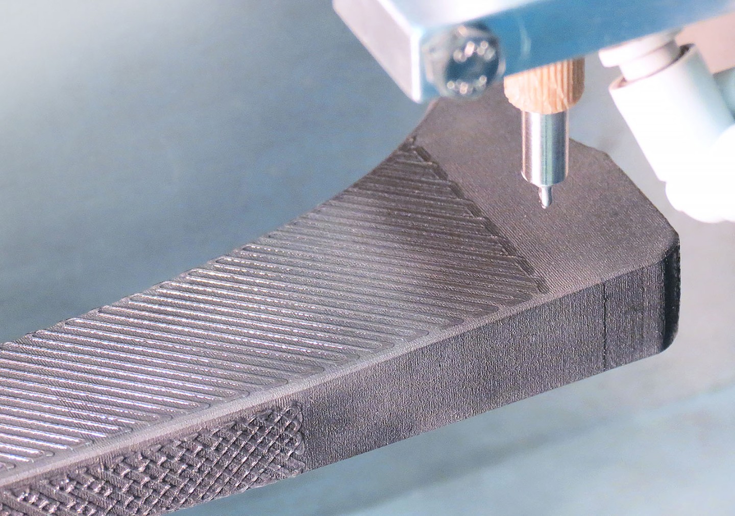 3D printed dopamine-based adhesive being applied to a titanium hip joint shaft