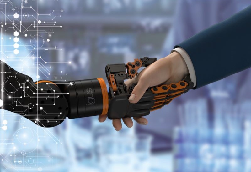 igus ReBel finger gripper humanoid hand shaking hands with human hand