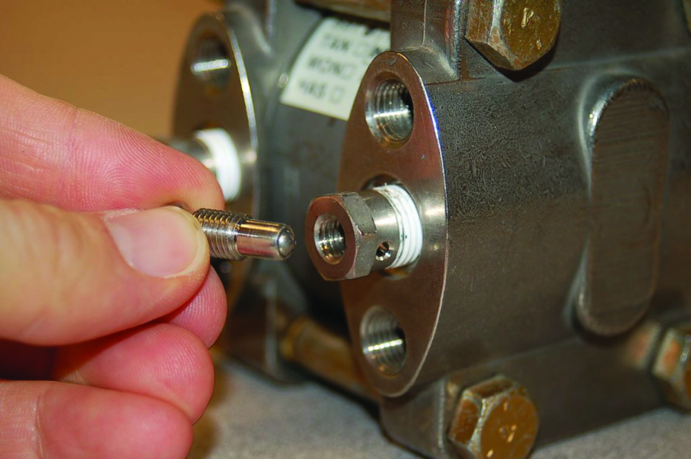 Close-up views of a plug bleed fitting