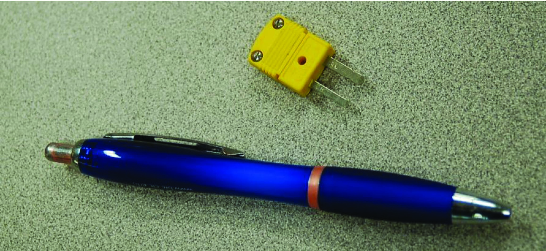 ballpoint pen and plug for size comparison